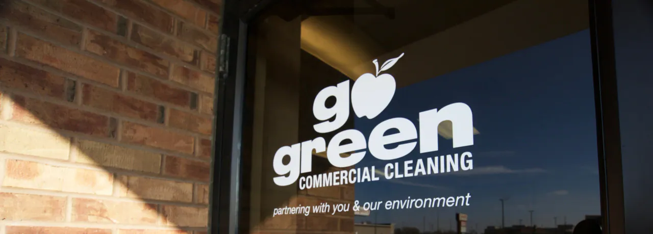 Go Green Commercial Cleaning signage on the window of the Bloomington office