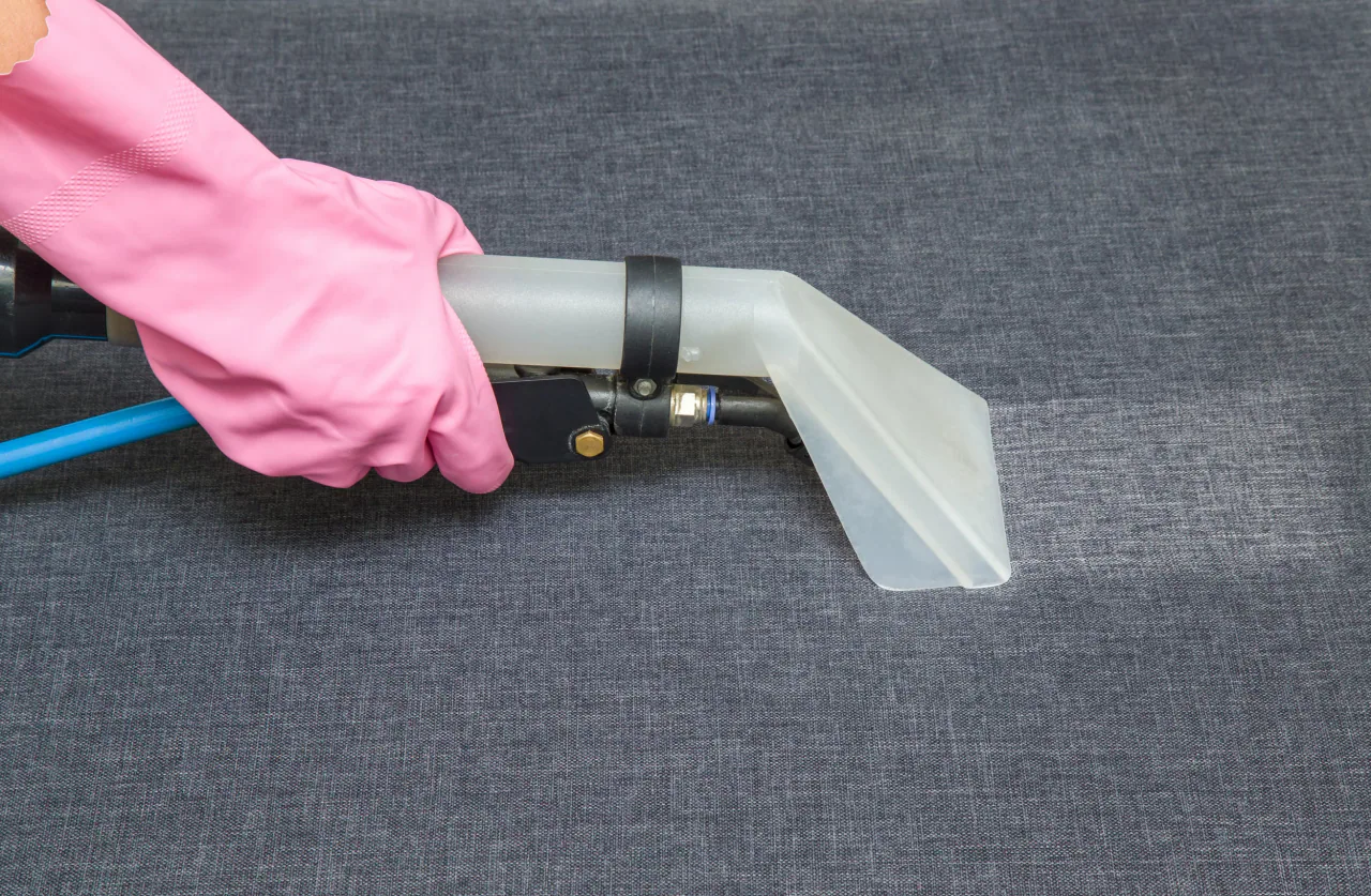 Upholstery extraction tool cleaning a sofa