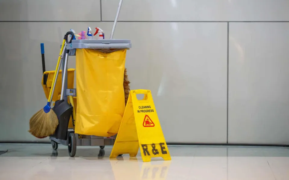 Janitorial cart with cleaning supplies in a commercial building